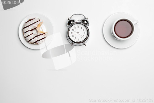 Image of The clock, cup, cake on white background