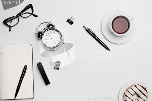 Image of The clock, pen, and glasses on white background