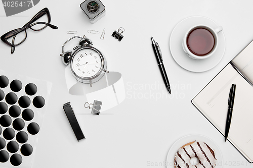 Image of The clock, pen, and glasses on white background