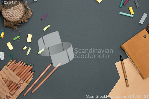 Image of Office desk table with pencils, supplies