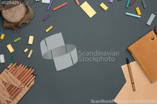 Image of Office desk table with pencils, supplies and cup