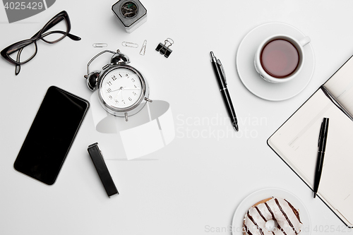 Image of Office desk table with cup, supplies, phone on white background