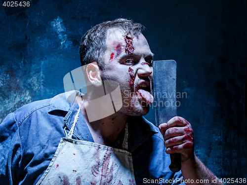Image of Bloody Halloween theme: crazy killer as butcher with a knife