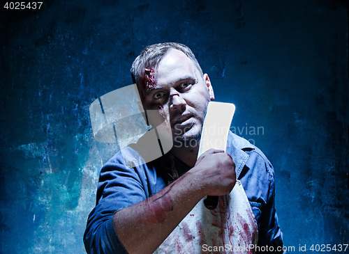 Image of Bloody Halloween theme: crazy killer as butcher with a knife