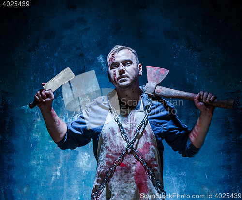 Image of Bloody Halloween theme: crazy killer as butcher with an ax