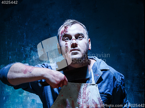 Image of Bloody Halloween theme: crazy killer as butcher with a knife