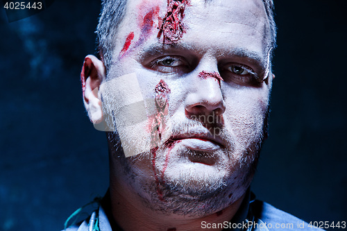 Image of Bloody Halloween theme: crazy killer as young man with blood