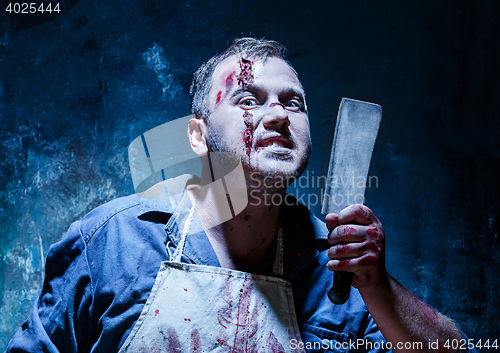 Image of Bloody Halloween theme: crazy killer as butcher with a knife