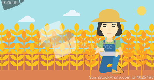 Image of Farmer with tablet computer on field.