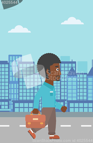 Image of Successful businessman walking with briefcase.