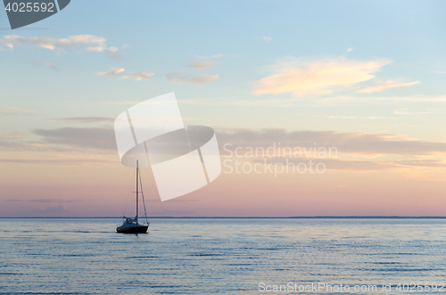 Image of Single sailboat in calm water