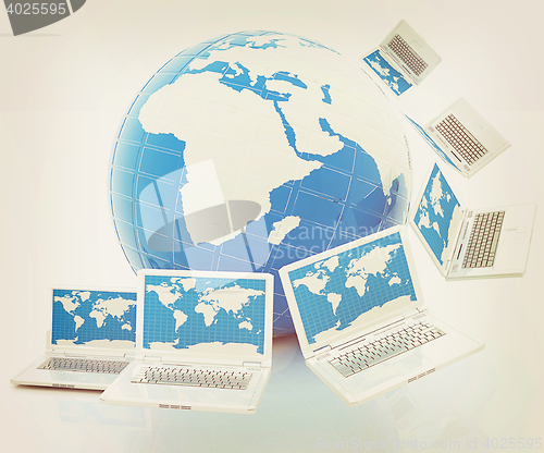Image of Laptops around the planet earth . 3D illustration. Vintage style