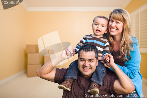 Image of Young Mixed Race Family In Room With Moving Boxes