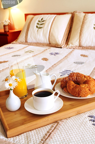 Image of Breakfast on a bed in a hotel room
