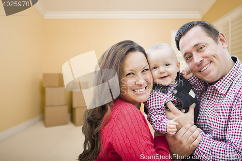 Image of Young Family In Room With Moving Boxes