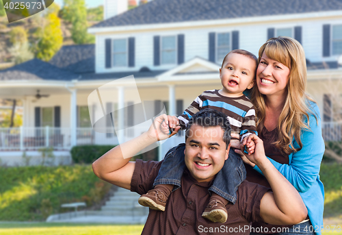 Image of Happy Mixed Race Young Family in Front of House