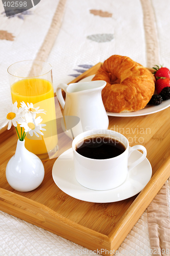 Image of Breakfast on a bed in a hotel room