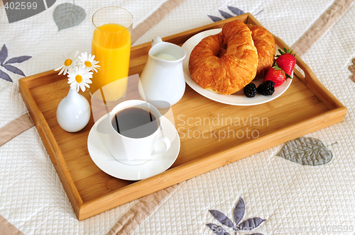 Image of Breakfast on a bed in a hotel room