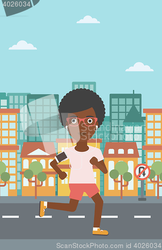 Image of Woman running with earphones and smartphone.