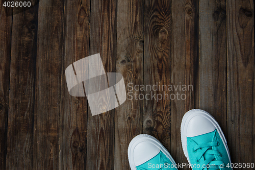 Image of socks of sneakers on wooden floor