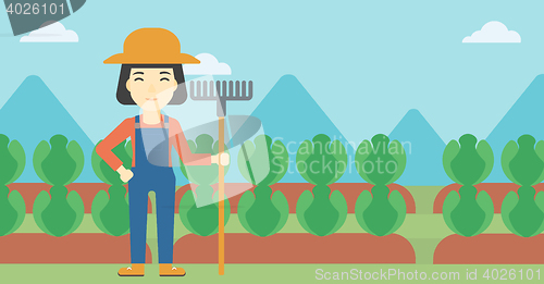 Image of Female farmer with rake vector illustration.