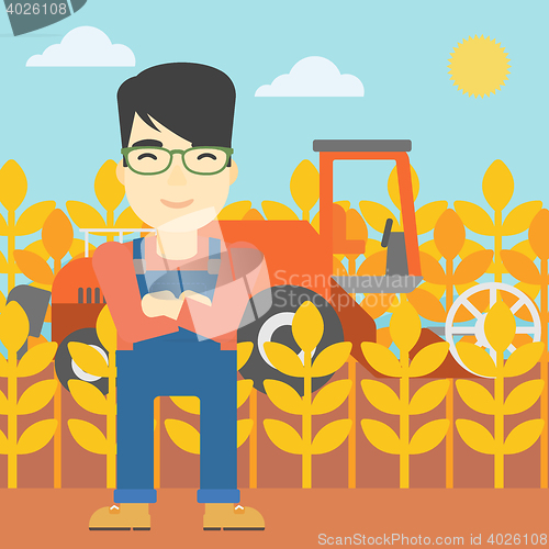 Image of Man standing with combine on background.