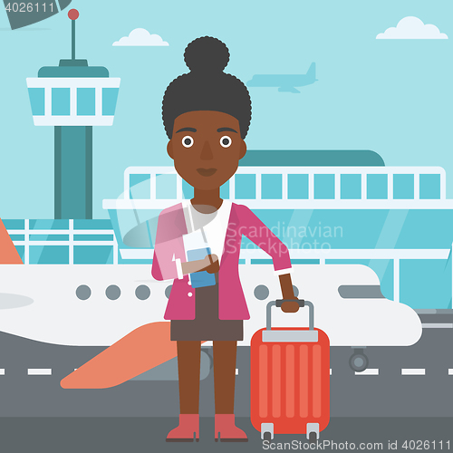 Image of Woman with suitcase and ticket at the airport.