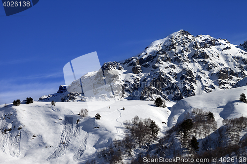 Image of Off-piste slope with track from avalanche on sunny day