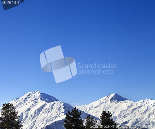 Image of Snowy mountains and blue clear sky at nice sun morning
