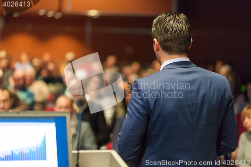 Image of Public speaker giving talk at Business Event.