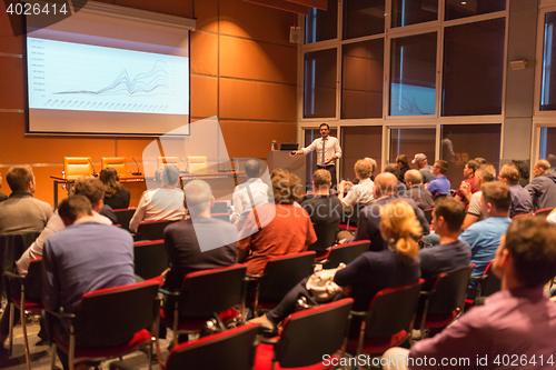 Image of Business speaker giving a talk in conference hall.