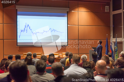 Image of Business speaker giving a talk in conference hall.