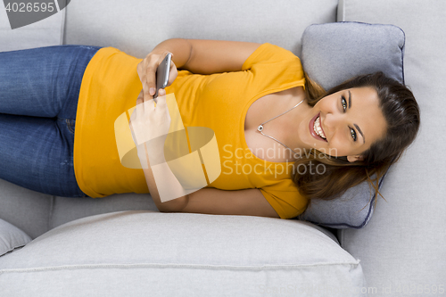 Image of Happy woman texting