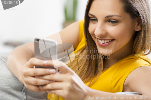 Image of Happy woman texting