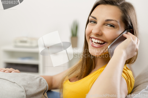 Image of Young woman talking at phone