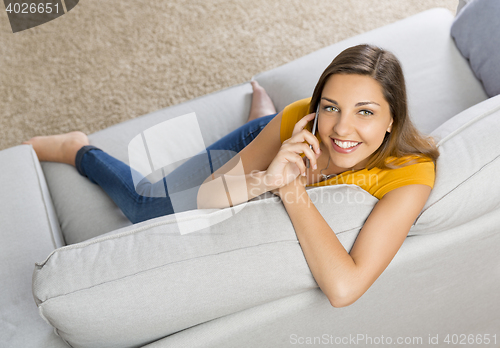 Image of Young woman talking at phone