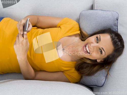 Image of Happy woman texting