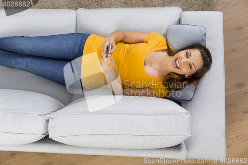 Image of Happy woman texting