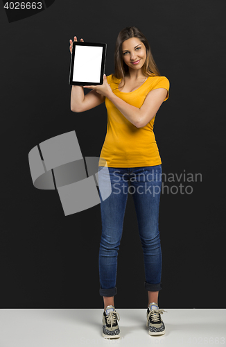 Image of Woman holding and showing a tablet