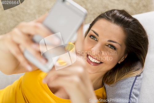 Image of Happy woman texting