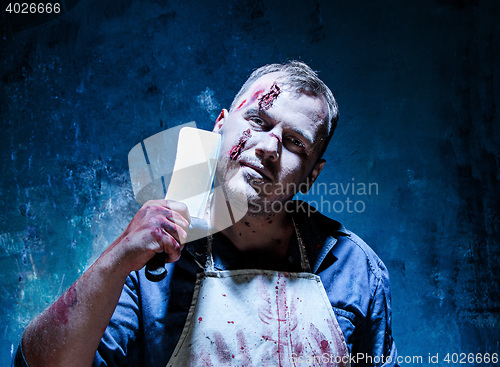 Image of Bloody Halloween theme: crazy killer as butcher with a knife