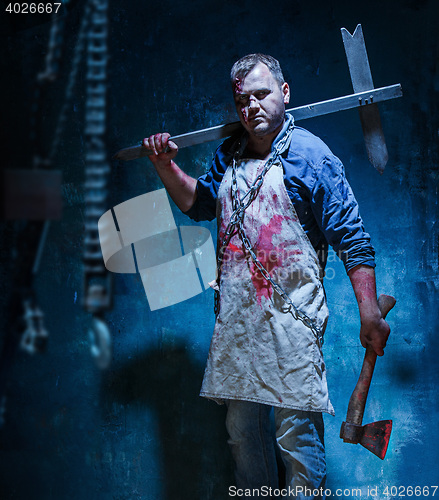 Image of Bloody Halloween theme: crazy killer as butcher with an ax