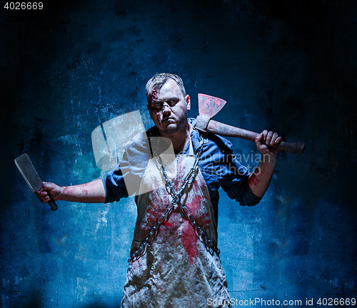 Image of Bloody Halloween theme: crazy killer as butcher with an ax