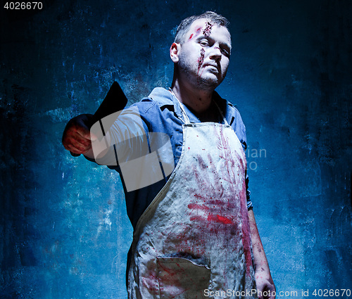 Image of Bloody Halloween theme: crazy killer as butcher with a knife