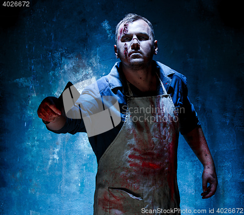 Image of Bloody Halloween theme: crazy killer as butcher with a knife