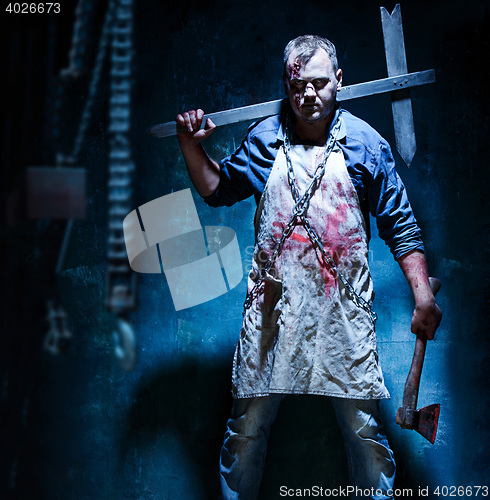 Image of Bloody Halloween theme: crazy killer as butcher with an ax