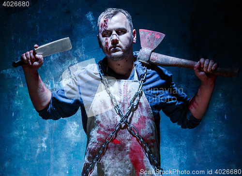 Image of Bloody Halloween theme: crazy killer as butcher with an ax