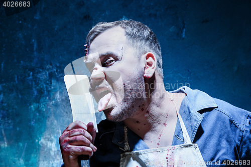 Image of Bloody Halloween theme: crazy killer as butcher with a knife