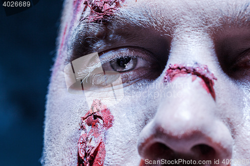 Image of Bloody Halloween theme: crazy killer as young man with blood