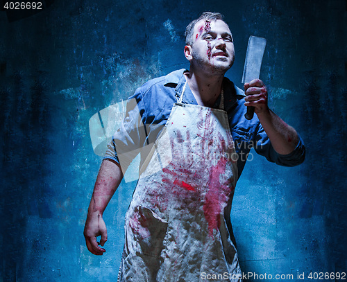 Image of Bloody Halloween theme: crazy killer as butcher with a knife